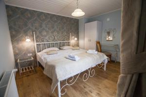 a bedroom with a white bed in a room at Pension Andronic in Timişoara