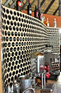a counter with a bunch of bottles of wine at Munga Eco-Lodge in Livingstone +59 photos