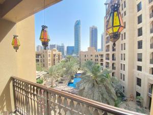 a balcony with palm trees and a view of a city at Durrani Homes - Old Town Lux 1 bed Besides Dubai Mall in Dubai
