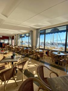 a restaurant with tables and chairs and large windows at Transatlantico in Naples