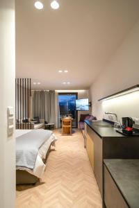 a hotel room with a bed and a kitchen at Alinea Suites Limassol Center in Limassol
