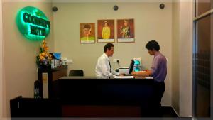 dos hombres parados en una caja registradora en una tienda en GoodHope Hotel, Kelana Mall, en Petaling Jaya