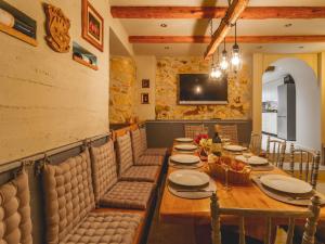 a dining room with a long wooden table and chairs at Mediterranean Luxury Villa Jele in Dobrinj