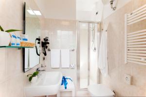 a bathroom with a sink and a shower and a toilet at Bike&Boat Argentario Hotel in Porto Santo Stefano