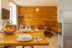a dining room with a table and a couch at Chalets Gardenia in Donovaly +14 photos
