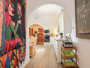 a kitchen with an archway and a dining room and a kitchen with at Torview House in Peebles