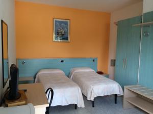 מיטה או מיטות בחדר ב-Hotel La Collinetta