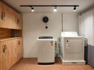a kitchen with two refrigerators in a room at Station8 Hostel in Bangkok