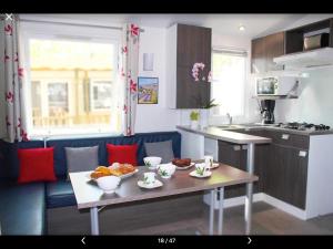 a kitchen with a table and chairs and a refrigerator at Best Holiday Port Grimaud in Grimaud