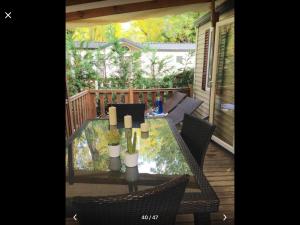 a patio with a table and chairs on a deck at Best Holiday Port Grimaud in Grimaud