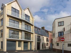 an apartment building with a balcony on a street at Harbourside Haven Apartment 1 in Weymouth
