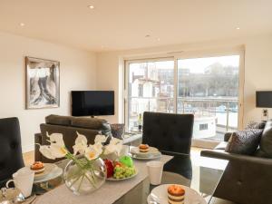 a living room with a table with fruit on it at Harbourside Haven Apartment 1 in Weymouth