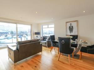 a living room with a couch and a table at Harbourside Haven Apartment 1 in Weymouth