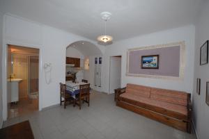 sala de estar con banco y mesa en Orfeas Apartments, en Kamari