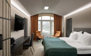 a hotel room with a bed and a television at Hotel Kakola in Turku