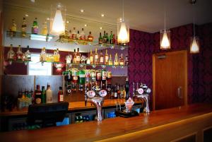 a bar with a lot of bottles of alcohol at The Aberlour Hotel in Aberlour