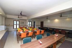 a large room with tables and chairs in a cafeteria at King's Queen Crown Mandarmoni in Mandarmoni