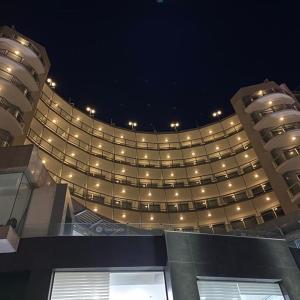 a large building with lights on it at night at The Preluna Hotel in Sliema +37 photos