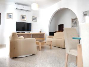 a living room with two chairs and a tv at Large apartment close to rocky beach MCRE1-1 in Sliema
