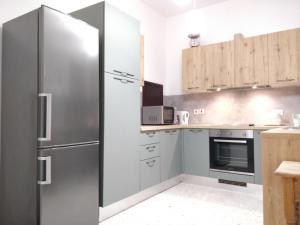a kitchen with a stainless steel refrigerator and cabinets at Large apartment close to rocky beach MCRE1-1 in Sliema