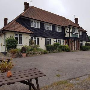 a house with a bench in front of it at New Forest Spacious 2 bed flat in Lymington