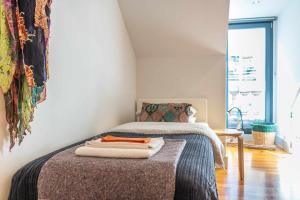 a bedroom with a bed with towels on it at CharmingLoft Lisbon Avenida Large and Stylish Apt in Lisbon