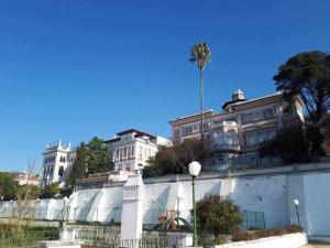 a group of buildings with a palm tree in the background at CharmingLoft Lisbon Avenida Large and Stylish Apt in Lisbon