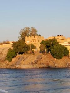 a building on an island in the water at Shipa's nubian house in Aswan