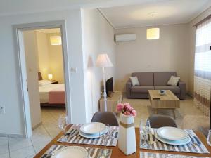 a living room with a dining table and a couch at Blue Yard Apartments in Kalamata