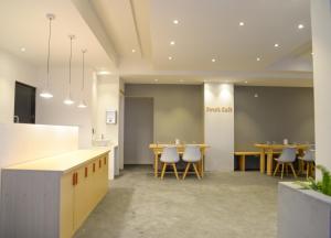 a dining room with tables and chairs in a building at Portia Hotel & Spa - Beachfront in Dhiffushi