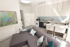 a living room with a couch and a kitchen at River View in Bath