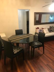 a dining room with a table and chairs and a couch at Mariu Apartment in Buenos Aires