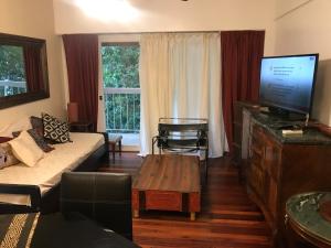 a living room with a couch and a flat screen tv at Mariu Apartment in Buenos Aires