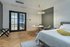 a bedroom with a bed and a table in it at Elysium Residence in Timişoara