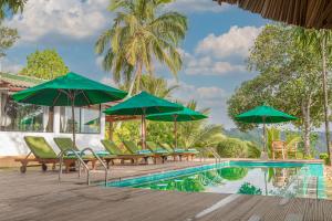 a pool with chairs and umbrellas next to a resort at CHILL VILLE, VIEW POINT HOTEL in Ella