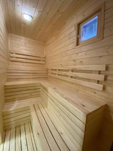 a large wooden sauna with a window in it at Klub Otdyha Liubogorie in Lyubytino