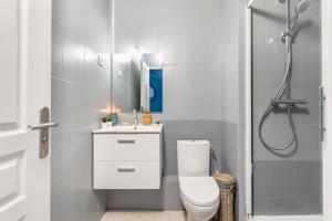 a white bathroom with a toilet and a shower at COLOR & COSY DARDILLY in Dardilly