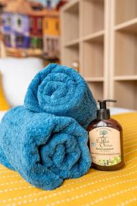 a blue towel next to a bottle of soap at COLOR & COSY DARDILLY in Dardilly