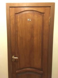 a wooden door in the corner of a room at Don-Antonio in Krasnodar