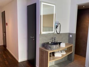 a bathroom with a sink and a mirror at Hotel B4 in Limburg an der Lahn