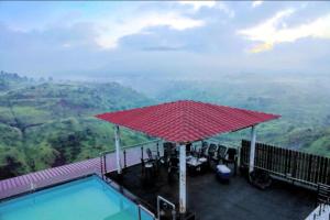 a swimming pool with a view of the mountains at Valley View Igatpuri in Igatpuri