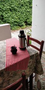 a pot on a table on a red and white table cloth at Plaza Hotel in Capilla del Monte