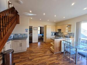 a kitchen with a table and a dining room at The Boat Yard in Appledore