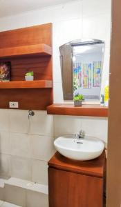 a bathroom with a sink and a fish tank at One Oasis Apartment CDO in Cagayan de Oro