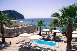 a resort with a swimming pool and chairs and umbrellas at Casthotels Baia delle Sirene in Forio d'Ischia