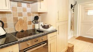 a kitchen with a sink and a counter top at Unicorn Cottage in Bakewell +22 photos