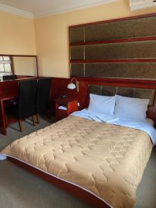 Postel nebo postele na pokoji v ubytování Hotel Kamel