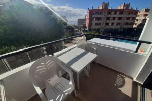 a balcony with a table and chairs on a balcony at Apartment near the beach in Playa de las Americas