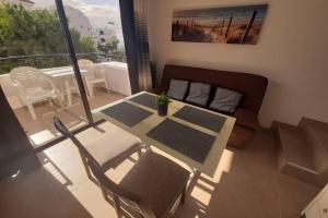 a living room with a table and chairs on a balcony at Apartment near the beach in Playa de las Americas