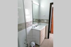 a bathroom with a white sink and a mirror at Apartment near the beach in Playa de las Americas